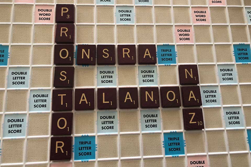 A photograph of a Scrabble board populated by non-English words